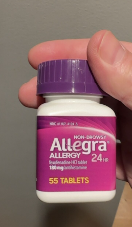 Photo of a medication bottle held in a hand